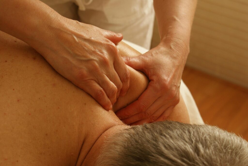 Professional massaging a a man's bare back
