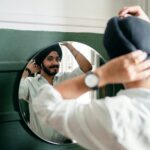 photo of Indian guy looking at mirror
